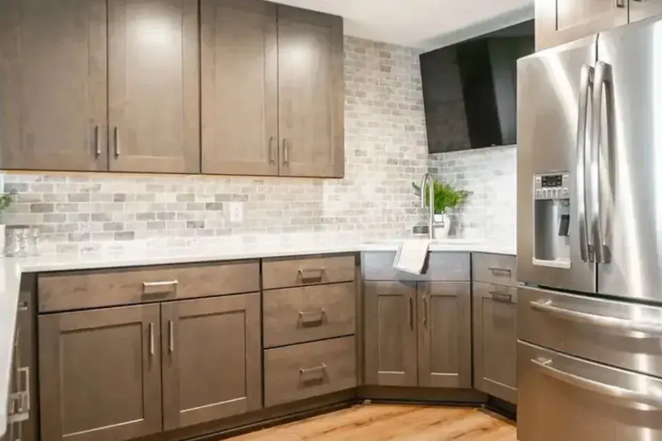 Kitchen with rich wood-tone cabinets and a stacked stone backsplash, refinished for a Denver, NC home.