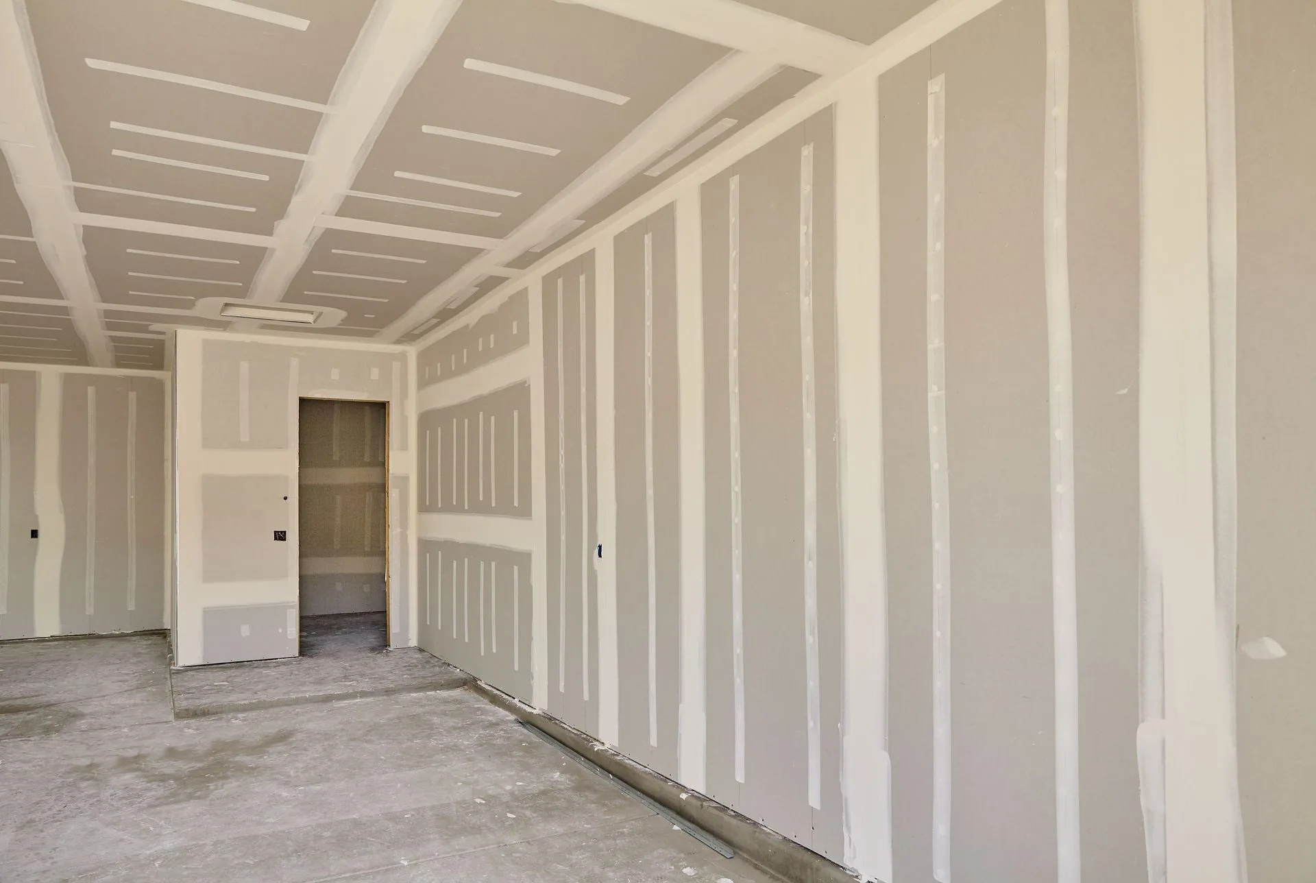 Taped and floated drywall walls and ceiling in a new Conover, NC room addition before finishing.